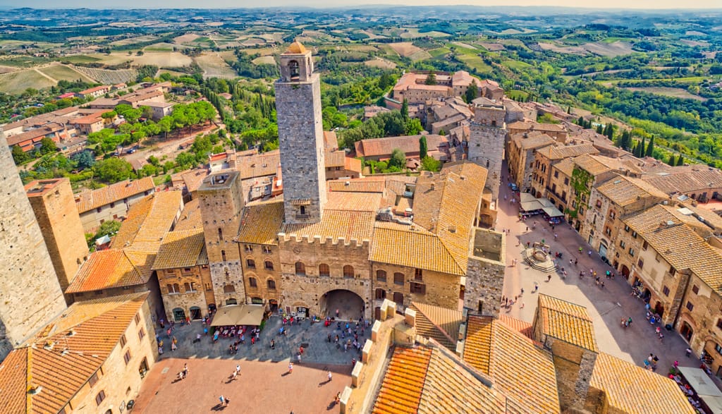 Dizzy top view of the medieval village of San Gimignano near Siena under the sun of Tuscany