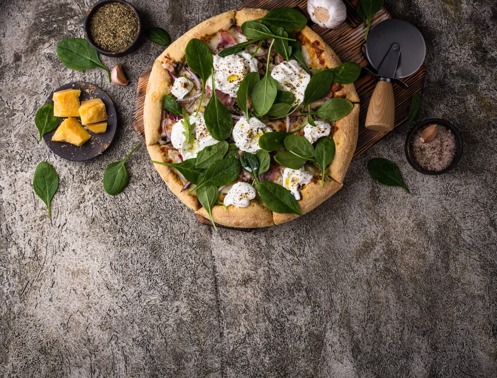 Italian pizza with soft cheese burrata or mozzarella and herbs