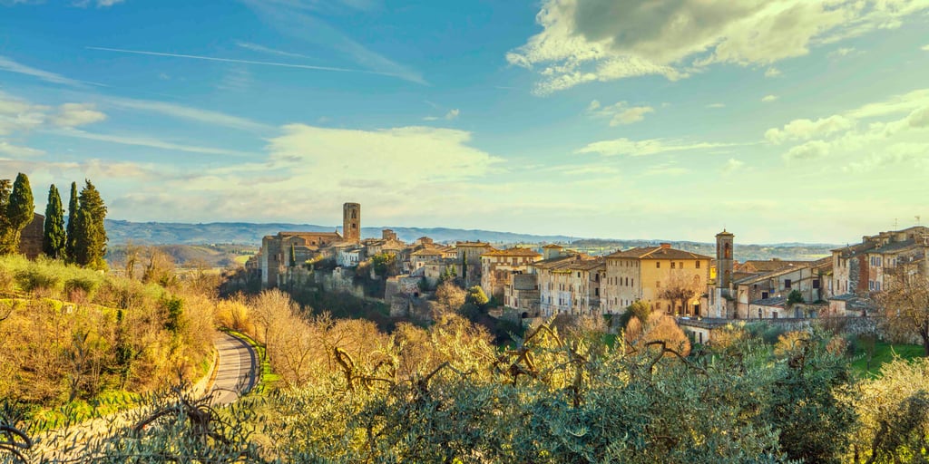 Colle Val d'Elsa town skyline, panoramic view and olive trees. City of crystal glass. Siena, Tuscany, Italy.