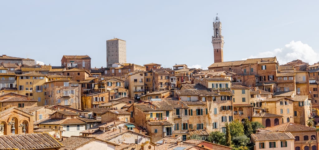 Cityscape of Siena town with bell tower of town hall in Tuscany region of Italy. Concept of visiting italian landmarks
