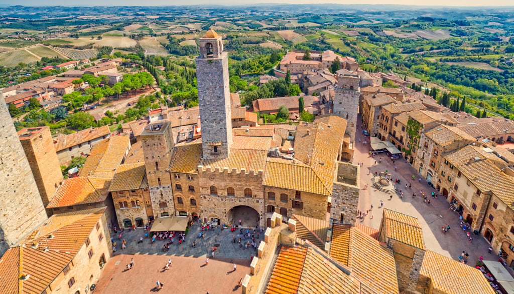 Dizzy top view of the medieval village of San Gimignano near Siena under the sun of Tuscany