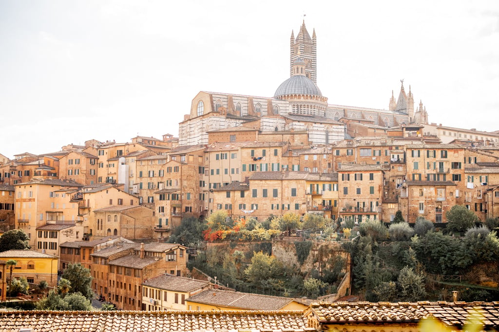 Cityscape of Siena town with Duomo cathedral in Tuscany region of Italy. Concept of visiting italian landmarks